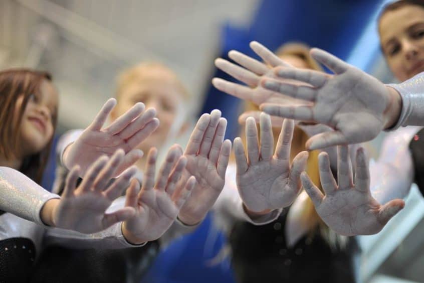 gymnasts show chalk on their hands 846x564 1